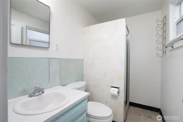 Three quarter bath with new linoleum.