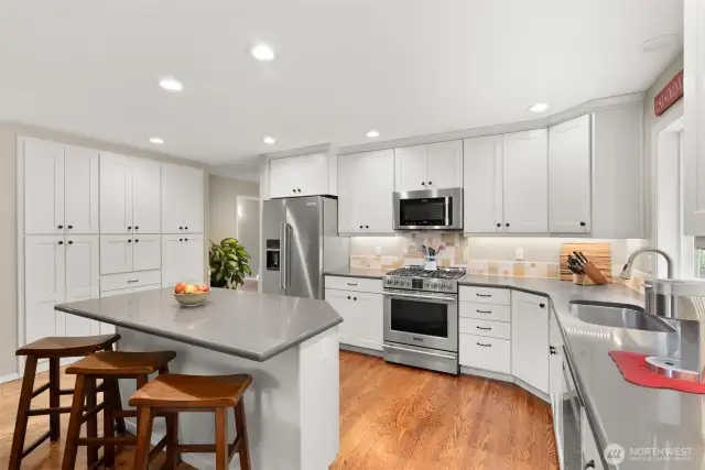 Updated kitchen with quartz counter tops, upgraded appliances and built in pantry.