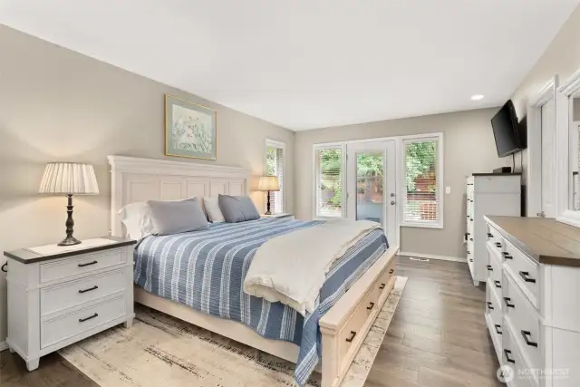 Comfortable primary bedroom with walk out access to private deck.
