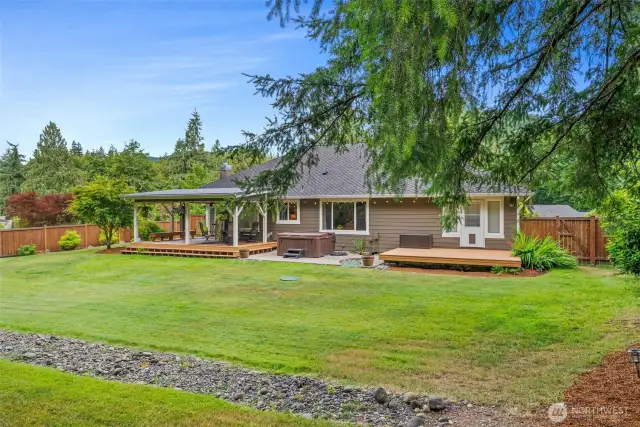 Large professionally landscaped backyard with sprinkler system