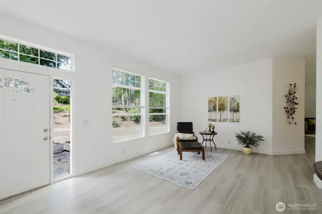 Spacious living room with laminate flooring and abundant natural light.