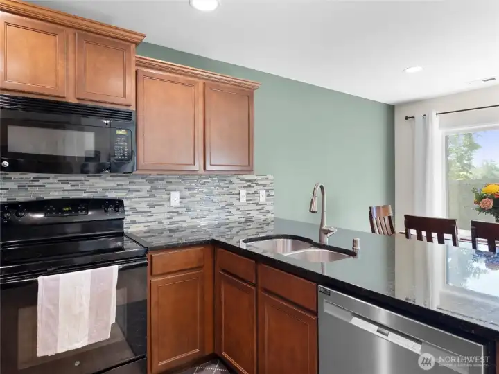 KITCHEN - Stone Counter serve-over, tile backsplash, SS sink & Dishwasher