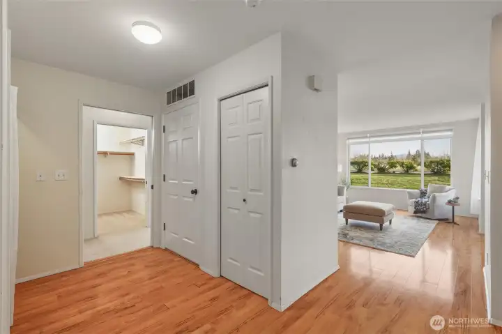 Looking toward the primary suite and the south-facing living room from the hallway off the entry.