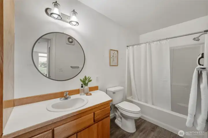 The primary suite has a lovely full bath that also has LVT flooring.