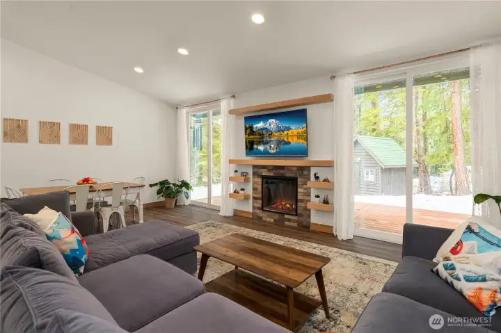 Oversized dual glass sliders off the great room open to the back deck, ideal for BBQs or relaxing in peaceful seclusion.