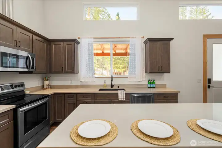 Kitchen window looks out to new covered front porch and kitchen garden space.