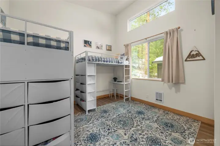 Bedroom 3 features a soaring 15' vaulted ceiling, full-size closet, and abundant natural light.