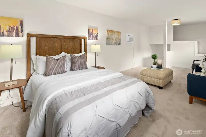 Another view of the upstairs bedroom showing a reading nook and extra storage to the far right.
