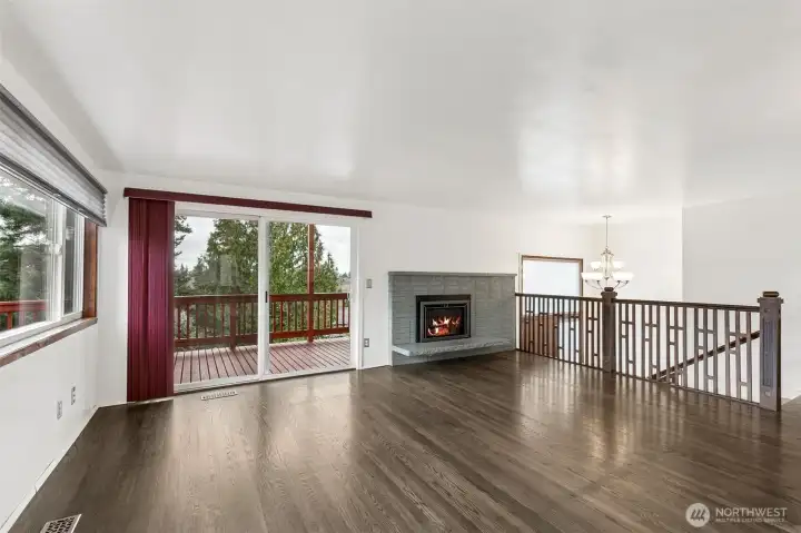 Living Room: Bright and airy living space featuring a gas fireplace and oversized sliding glass doors that perfectly frame the puget sound and territorial views.