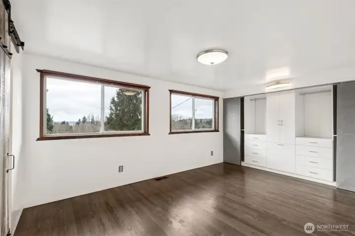 Primary Suite: Spacious primary suite on the main floor, thoughtfully updated for comfort and maximum natural light.