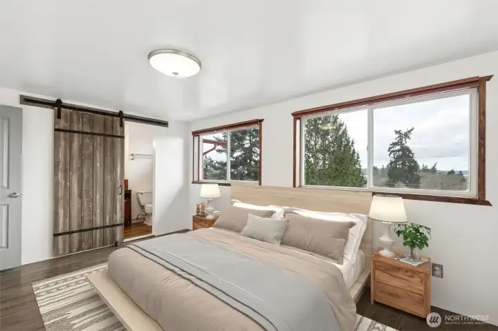 Primary Suite: Spacious primary suite on the main floor, thoughtfully updated for comfort and maximum natural light.