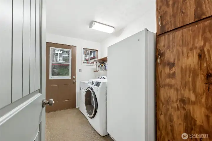 Utility Room: Recently renovated utility room featuring a high-capacity filtered water system for the entire home