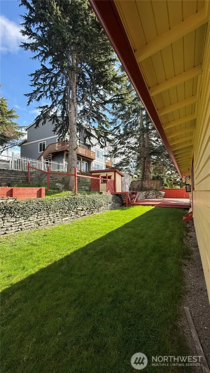 Energy-efficient home featuring 33 solar panels and double windows, chicken coop wood shed, raised garden beds plus older greenhouse.