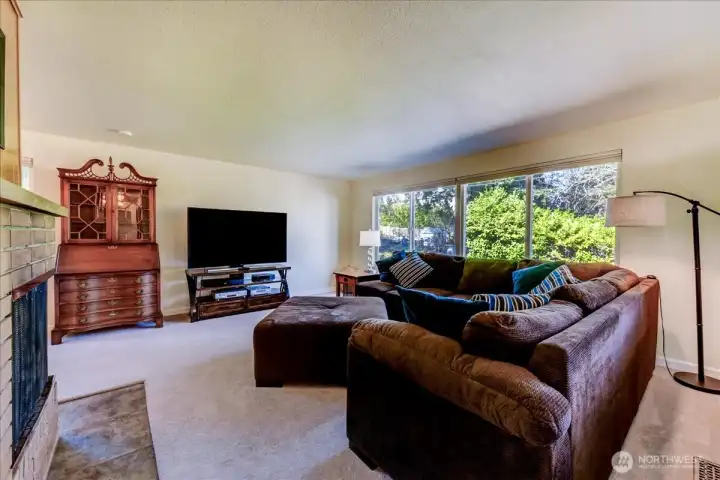 Living room view two with large picture window and built-in bookcase
