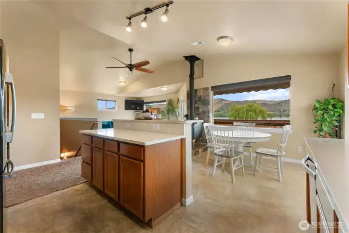 Kitchen with newly added Quartz countertops and tile flooring. Lakeview from kitchen, dining table and Island.