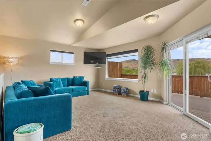 Living room adjacent the kitchen with access to the deck through slider with Lakeview.
