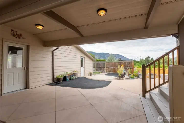 First door to the left is entry into the garage, Far door is entry into workshop, steps to the right are access into the house.