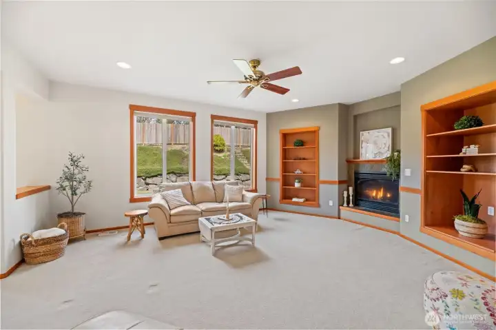 Family room with gas fireplace and ceiling fan
