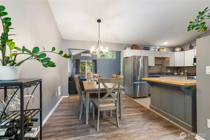 Dining room located adjacent to kitchen and between living spaces