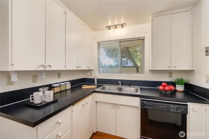 Kitchen has a small footprint, but offers a lot of cabinets for storage.