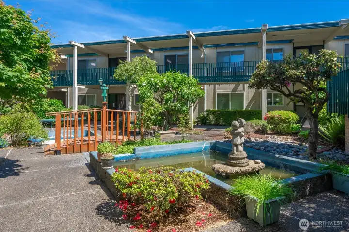 Courtyard has relaxing pond and an outdoor pool. There is a clubhouse as well.