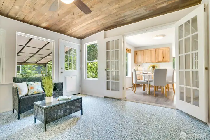 French doors open from the dining room to a bright sunporch. French doors open from the dining room to a bright sunporch.
