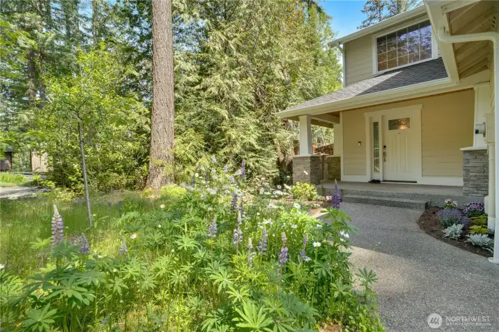 Now let's take the full tour. A wildflower garden and weeping cherry tree grow beside the path to the covered front porch. Now let's take the full tour. A wildflower garden and weeping cherry tree grow beside the path to the covered front porch.