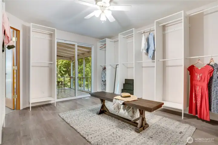Take the door from the primary bedroom into this large dressing room with plentiful shelving and sliding glass doors to the screened porch. Take the door from the primary bedroom into this large dressing room with plentiful shelving and sliding glass doors to the screened porch.