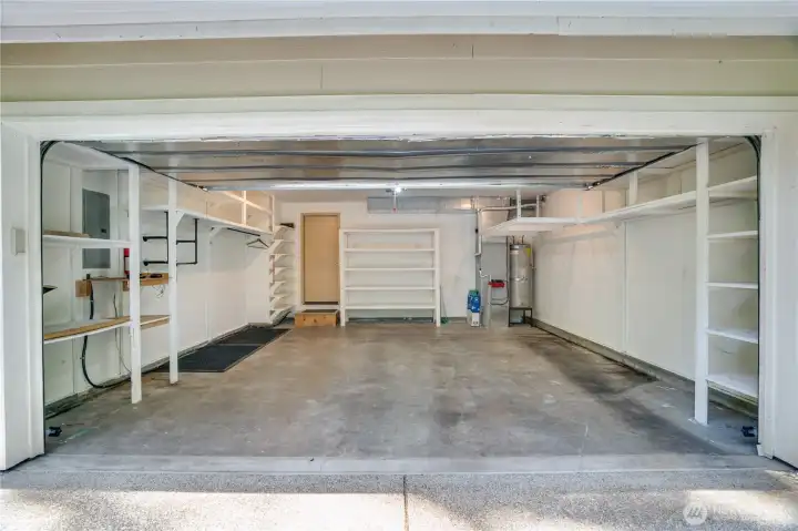 The 435 sq ft attached, 2-car garage is all cleared out and ready for parking and storage. The interior door opens into the hall between the half bath and family room The 435 sq ft attached, 2-car garage is all cleared out and ready for parking and storage. The interior door opens into the hall between the half bath and family room