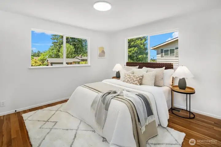 Spacious primary bedroom with hardwood floor. Spacious primary bedroom with hardwood floor.