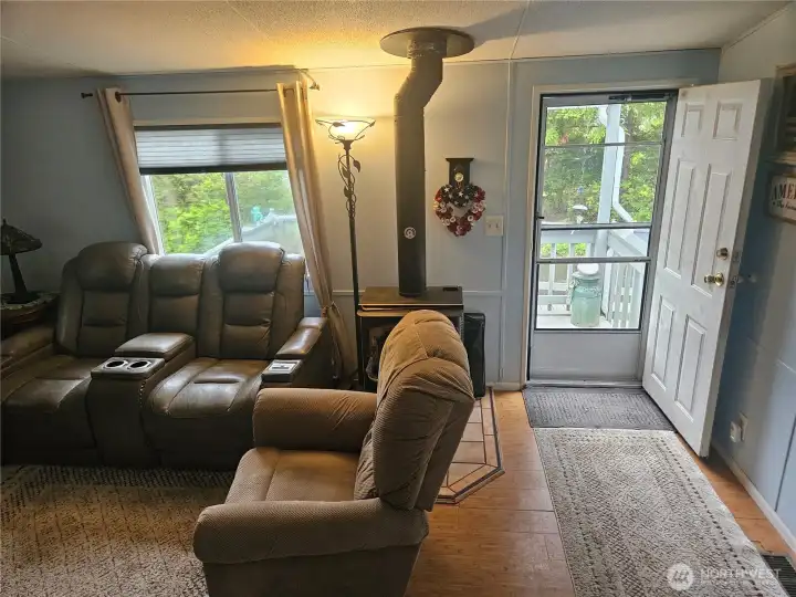 Living room with a wood burning stove to heat the whole house if you desire. Living room with a wood burning stove to heat the whole house if you desire.