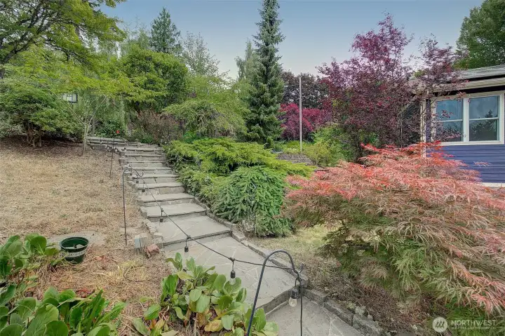 Stone steps lead from the cul de sac to the driveway.