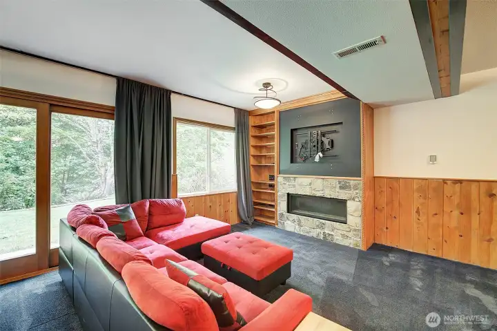 Downstairs rec room with gas fireplace and blackout curtains.