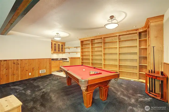 Pool table and wet bar with drawer dishwasher.