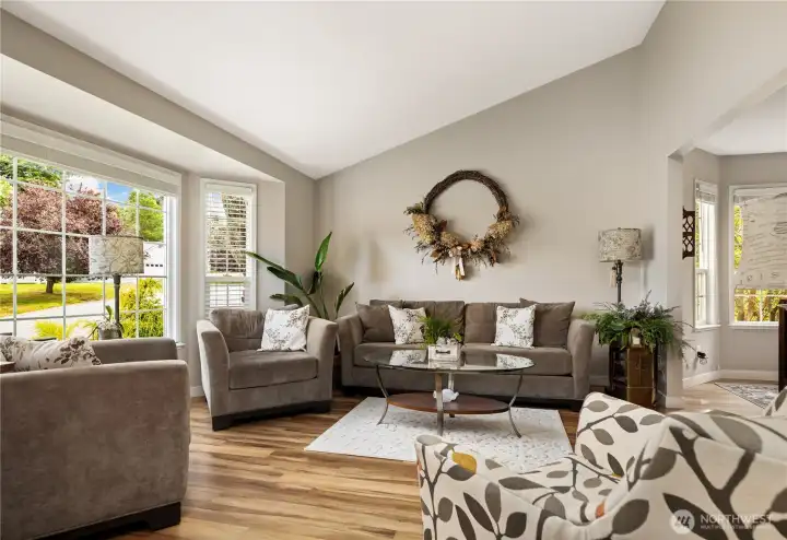 Vaulted Living room with grand windows allowing abundant natural light