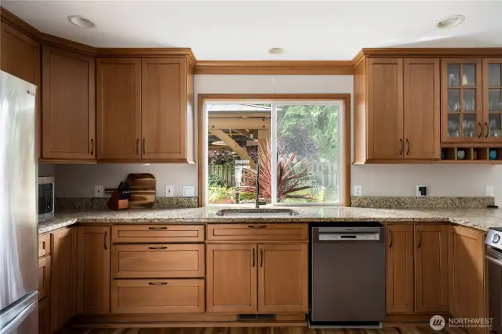 Custom Kitchen with new Granite countertops and appliances.  Kitchen window looks out to gorgeous backyard