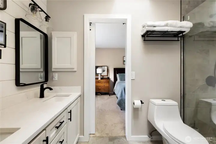 New bathroom with double sinks, walk in tile shower, heated tile floors
