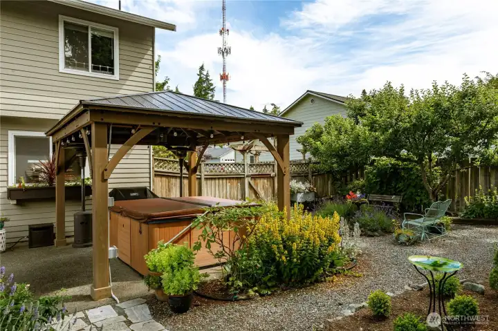 Hot tub under gazebo so you can enjoy it all year long.  Backyard is very private