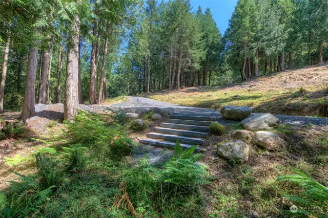 Granite steps lead you to a path through the forest to the large pond.