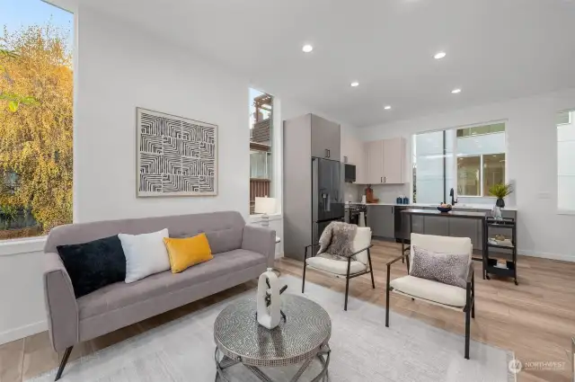 This cozy seating area offers the perfect blend of modern sophistication and warmth. Large windows frame views of lush greenery, creating a peaceful retreat.