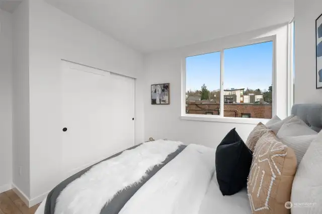 This secondary bedroom offers comfort and charm, with plenty of closet space and a peaceful retreat for family or guests.