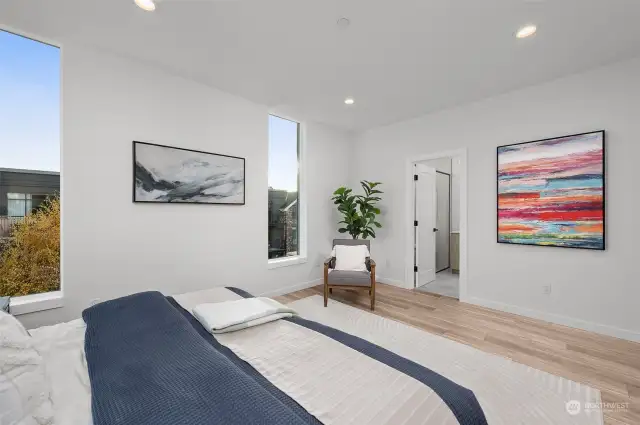 The expansive primary suite has space to create a nook to read in the morning, creating the perfect retreat for relaxation and inspiration.
