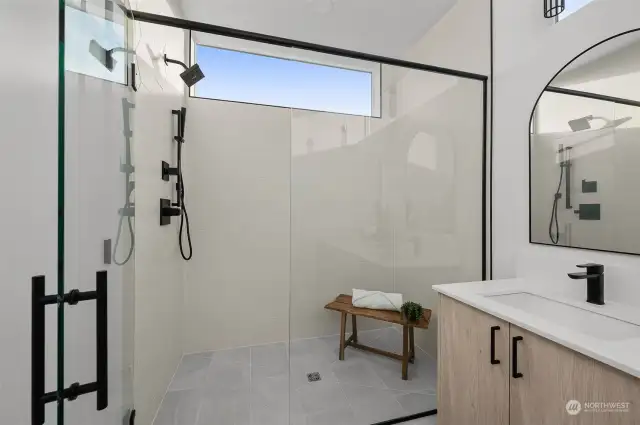 Step into a spacious, glass-enclosed walk-in shower with modern fixtures and clean lines—a private sanctuary for relaxation.