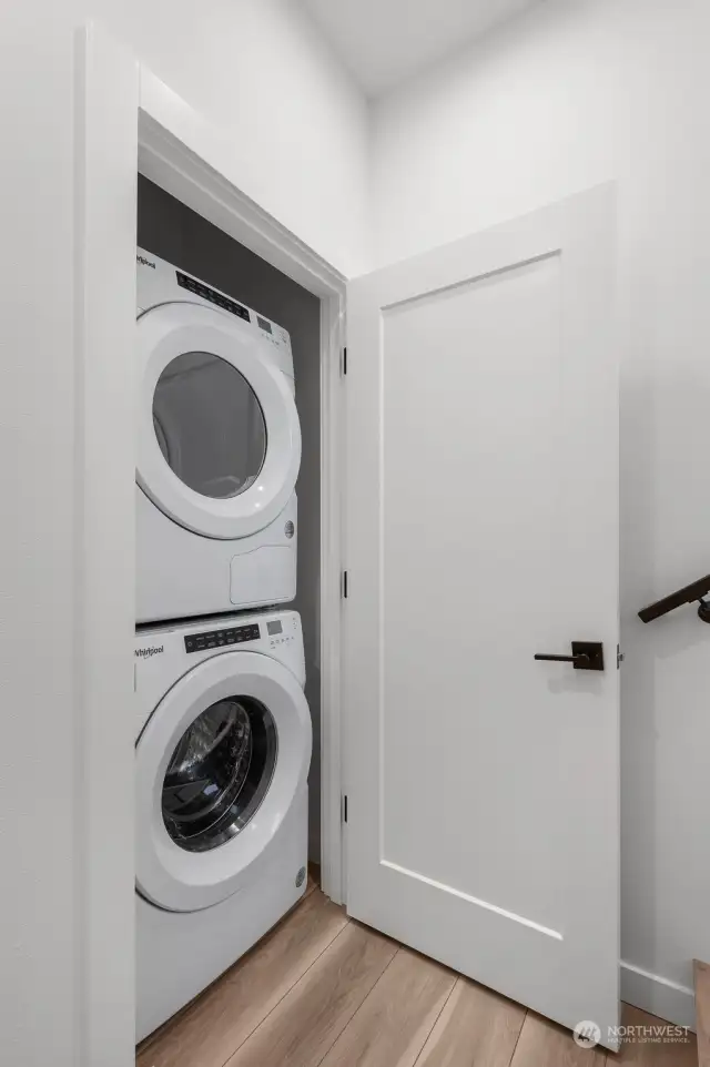 Convenient in-unit laundry tucked away in a discreet closet offers practicality and style.