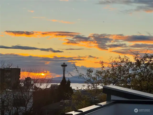 Unwind with mesmerizing Space Needle and Puget Sound views during a perfect golden-hour sunset.
