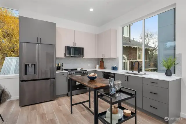 This kitchen is a showstopper! With its modern two-tone cabinetry, sleek stainless steel appliances, and generous natural light pouring in, it’s the heart of this home.