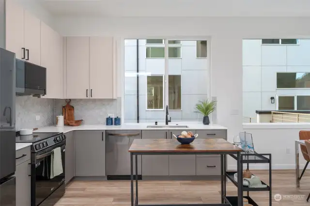 Enjoy a kitchen designed for both cooking and gathering. With its spacious countertops, ample storage, and clean lines, hosting friends or whipping up weeknight meals becomes a joy.