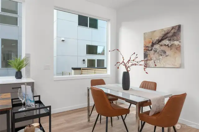 Savor every meal in this elegant dining nook, framed by large windows welcoming natural light.