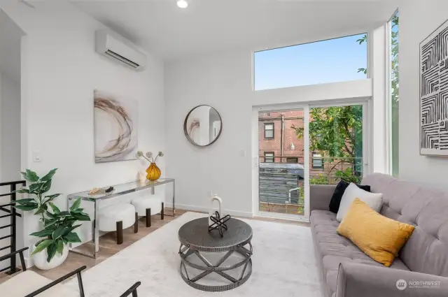 Natural light streams into this bright and open living area, creating a modern and inviting space. Perfect for relaxing or entertaining, this room is where style meets comfort.
