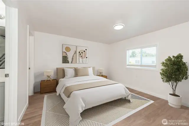 The spacious primary bedroom offers a serene retreat with plenty of natural light and a generous walk-in closet for all your storage needs.